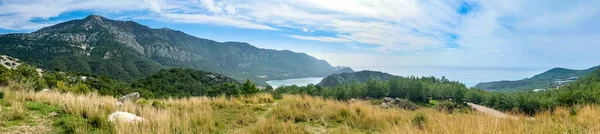 stock image Panoramic view of beautiful mountain and sea landscape with golden grass field and blue sky. Turkey.