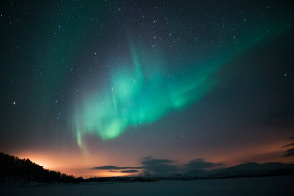 aurora borealis at night in the mountains