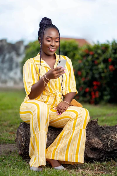 excited african lady with smart phone