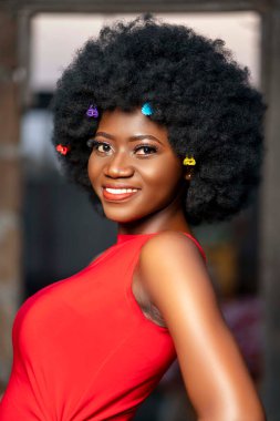 image of beautiful african lady - black afro cheerful woman in a red dress outside