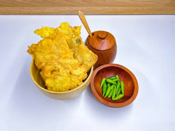 stock image Traditional Indonesian Food Called Tempe Goreng or Mendoan or Fried Tempeh with Flour Batter served with Green Cayenne Pepper or Green Colored Chilli on Isolated White Background. High quality photo