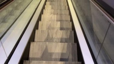 Descent from moving escalators