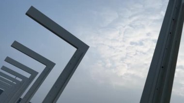 metal bent modern posts on blue sky