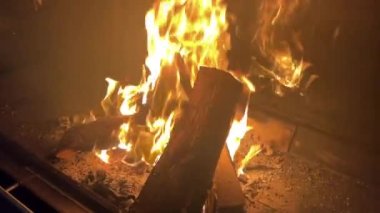 Wood burns in the fireplace in slow motion