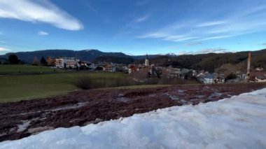 Melting snow in the city between the mountains