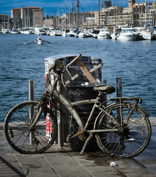 Çöp kutusunun yanında eski bir bisiklet.