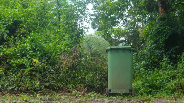 green trash bins in tourist spots