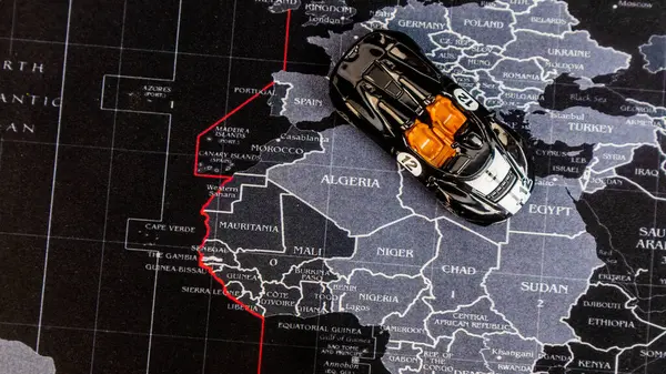a black toy car over the map