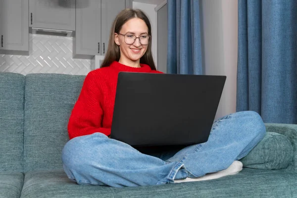 Happy Smiling Young Woman Red Sweater Jeans Glasses Sitting Couch — Stock Photo, Image
