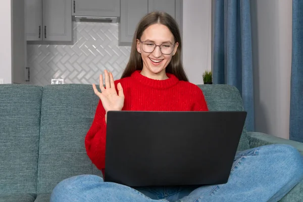 Young Smiling Woman Glasses Red Sweater Waves Her Hand While — Stock Photo, Image