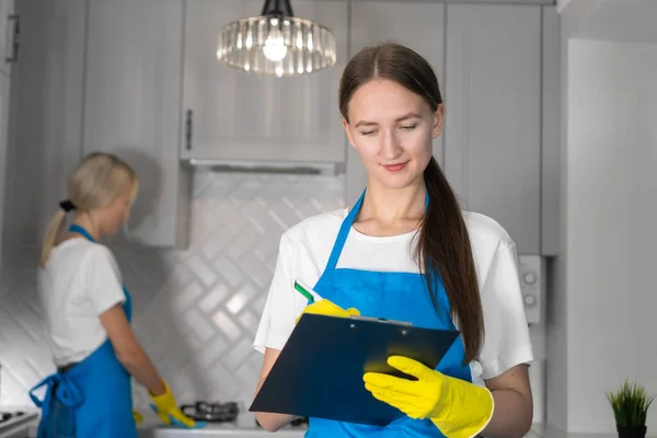Young Woman Professional Cleaning Company Uniform Notes Writes List Work — Stock Photo, Image