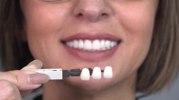 惠特化概念 牙科护理 植入物的供应商 在牙科诊所 美丽的白种人老年妇女笑得完美 选择了牙齿的色调 现代医学 — 图库视频影像