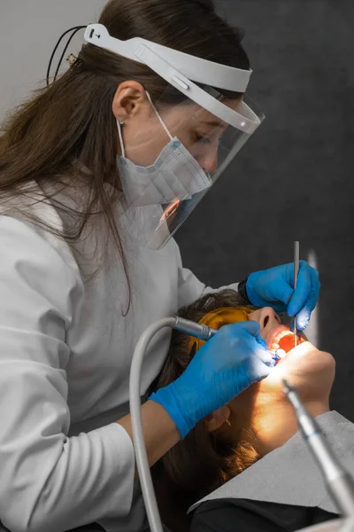Mujer Dentista Trata Los Dientes Paciente Joven Clínica Dentista Usa —  Fotos de Stock