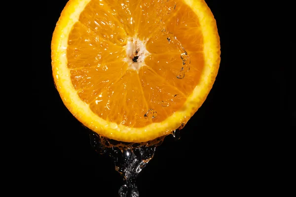 Közelkép Egy Szaftos Narancssárga Szelet Folyó Víz Fekete Háttér Makro — Stock Fotó