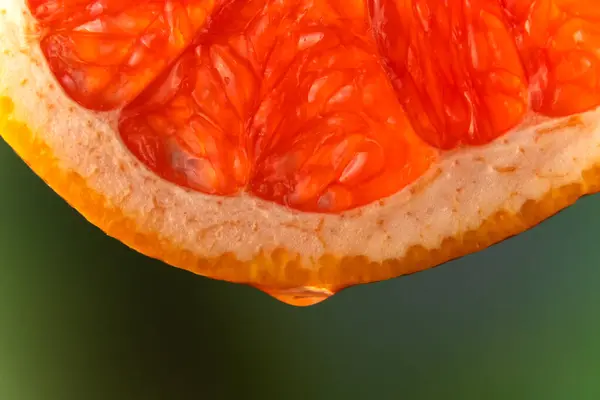 Red Grapefruit Juice Essential Oil Dripping Fresh Slice Blurry Green — Stock Photo, Image