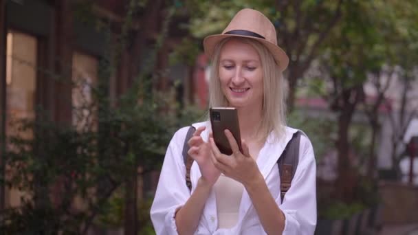Caucasienne Attrayante Voyageuse Touristique Chapeau Chemise Salon Regardant Smartphone Souriant — Video