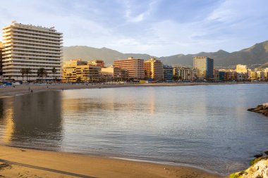 Playa de los Boliches, calm Mediterranean Sea and Fuengirola city seafront with hotels. Fuengirola, Costa del Sol, Malaga province, Andalusia, Spain.
