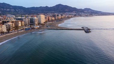 Aerial view of Fuengirola city seafront, beach, hotels, mountains and Mediterranean Sea. Dawn. Fuengirola, Costa del Sol, Malaga province, Andalusia, Spain.
