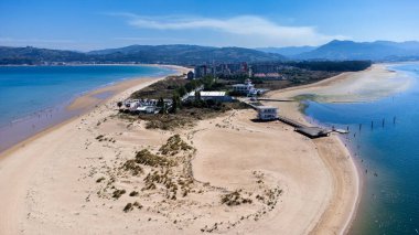 Aerial view of the sandy dune of Laredo, La Salve and Regaton beaches, the Cantabrian Sea, the Treto river, the city, and the surrounding mountains. Laredo, Cantabria, Spain. clipart