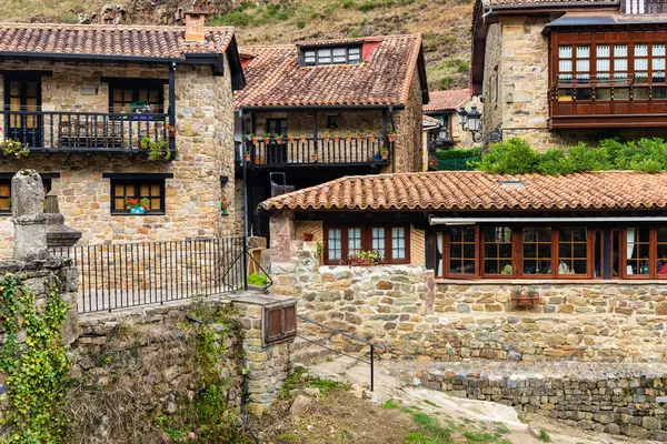 stock image Rural stone mountain houses with wooden verandas and red tiled roofs. Barcena Mayor, Cantabria, Spain.