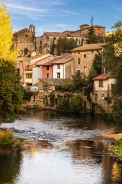 View of the Ega river, old buildings along its banks, and the Convent of Santo Domingo on the hill. Estella-Lizarra, Navarra, Spain clipart