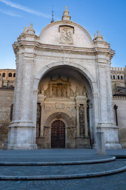 Main entrance of the Tarazona Cathedral (Catedral de Nuestra Senora de la Huerta de Tarazona), featuring a large arch and relief sculptures. Tarazona, Province of Zaragoza, Aragon, Spain. clipart