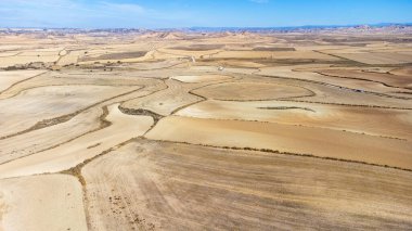 Aerial view of the Bardena Blanca, a semi-desert valley with hillocks in the distance. Bardenas Reales natural park, Navarra, Spain. clipart