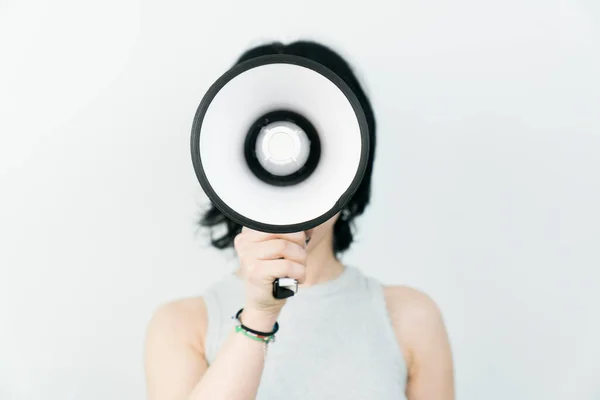 stock image Cropped shot of a young woman holding a mega phone while posing against