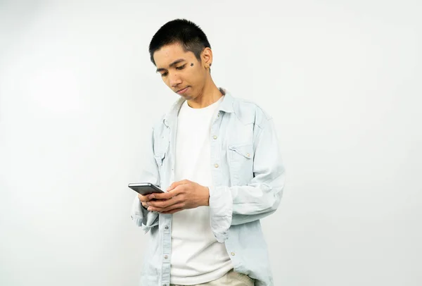 Young asian man playing mobile game. asian young man looking at smartphone