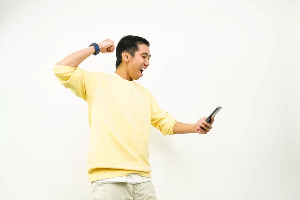Young asian man playing mobile game. asian young man looking at smartphone