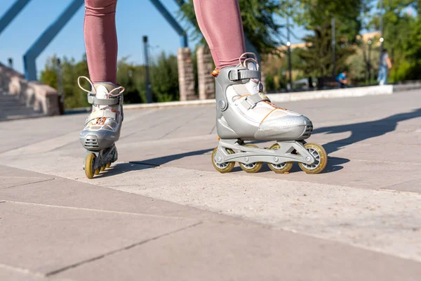 Close-up of woman\'s legs with inline skates