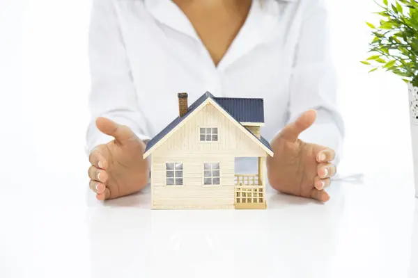 woman with house model real estate concept