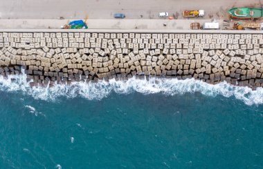 Aerial view of the sea stone breakwater. Beautiful ocean wallpaper for tourism and advertising. clipart