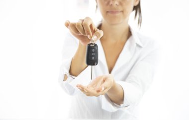 Woman holding a car key in her hands