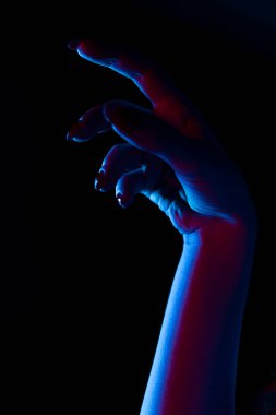 Karanlık arka planda kadın eli silueti, yakın plan.,