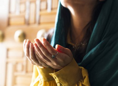 Başörtüsü ve başörtüsü takan Müslüman kadın camide elleri havada dua ediyor. Din dua kavramı.