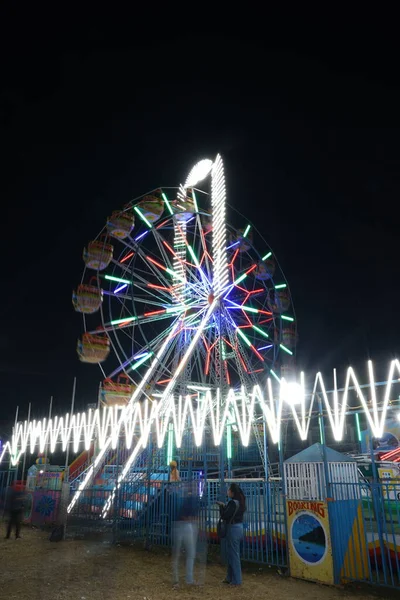 Giant Ferris wheel in indian fair at night, vertical photographs, colorful lights in giant ferris wheel, indian giant ferris wheel, night fair rides