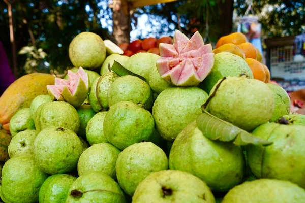Fresh and Tasty Guavas Selling on street, Local green guava fruits with pink pulp and seeds selling in local market of india