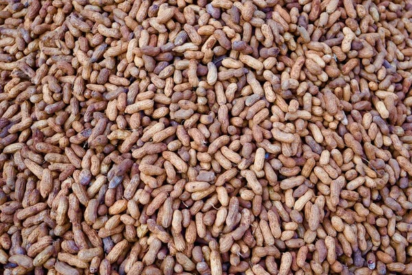 Close up of peanut or groundnut Unpeeled selling in market in india, Peanuts in bulk, market display, selling peanuts roadside