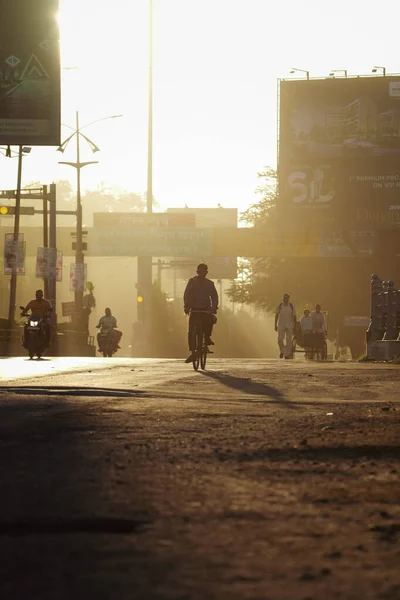Beautiful morning of raipur, morning empty road with sun rays or light striking on road, people at morning in raipur, chhattisgarh,india, beautiful yellow morning sun rays , people going to work