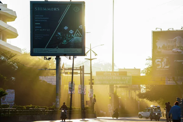 1 january 2023, raipur, chhattisgarh, morning sun rays or lights passing through buildings and holdings and rays falling on empty road of raipur, chhattisgarh