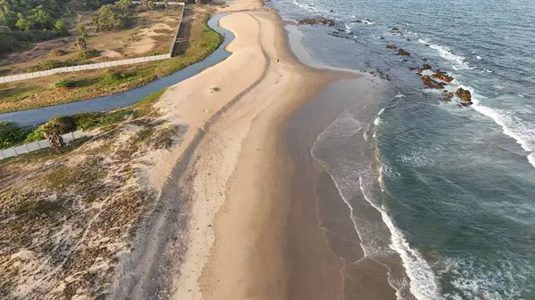 Sakin suları, kumlu sahili ve doğal tepe manzarası olan sahili, dağ arkası sakin sahili, yumuşak dalgaları ve altın saat ışığı olan sakin sahili, narin okyanus dalgaları ve arka planda tepeleri olan güzel bir sahil manzarası..