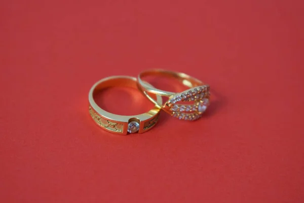 Close Up Golden ring with diamond on isolated red background