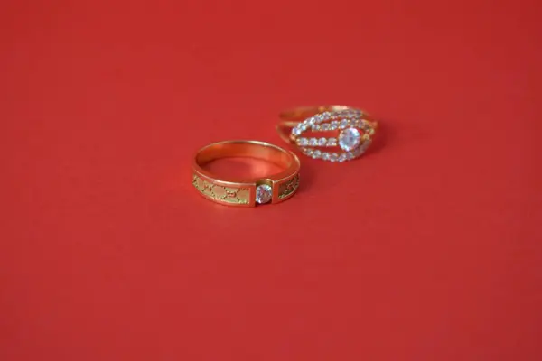 Close Up Golden ring with diamond on isolated red background