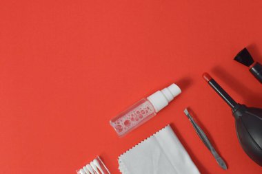 Kamera hava üfleyici, mikrofiber, fırça ve daha fazlası için temizlik seti. Kırmızı arkaplanda izole