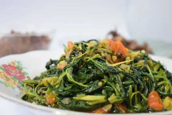 stock image Close up stir fried spinach on white plate isolated white background