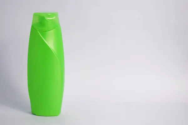 Green blank bottle shampoo minimalist bakcground, hair care bottle mock up product.