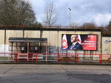 Zvolen, Slovakia, February 24, 2024:City transport stop. Near it is an election billboard with presidential candidate Peter Pellegrini. clipart