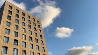 Akşam güneşinde bulutlu gökyüzü olan bir otel gökdeleninde. Yüksek kalite 4k görüntü