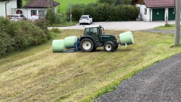 Traktor Zbierający Bele Siana Łące Latem Wysokiej Jakości Materiał — Wideo stockowe